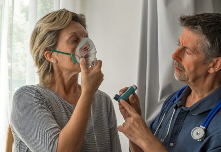 Oxygen,Face,Mask,Is,Placed,On,A,Woman,Patient,Struggling